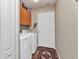 Well-equipped laundry room with a full-size washer and dryer and storage cabinets at 18382 Arapahoe Cir, Port Charlotte, FL 33948