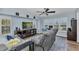 Comfortable living room with hardwood flooring, shutters, and ceiling fan at 18382 Arapahoe Cir, Port Charlotte, FL 33948