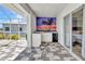 Outdoor kitchen with a sink, mini fridge and a mural of palm trees at sunset at 18382 Arapahoe Cir, Port Charlotte, FL 33948