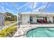 A view from the pool of the white aluminum structure around the pool and covered patio at 18382 Arapahoe Cir, Port Charlotte, FL 33948