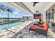 Outdoor patio with swimming pool, an outdoor kitchen, and comfortable seating areas at 18382 Arapahoe Cir, Port Charlotte, FL 33948