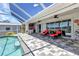 View of the covered patio with a well-maintained pool, outside kitchen, and outdoor seating at 18382 Arapahoe Cir, Port Charlotte, FL 33948