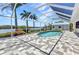 An aerial view of the pool surrounded by an aluminum frame with a view of the river at 18382 Arapahoe Cir, Port Charlotte, FL 33948