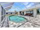 Back patio featuring a swimming pool, an outdoor kitchen, and comfortable seating areas at 18382 Arapahoe Cir, Port Charlotte, FL 33948
