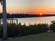 Scenic waterfront view with a tranquil sunset, providing a relaxing and serene atmosphere at 18382 Arapahoe Cir, Port Charlotte, FL 33948