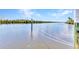 Serene waterfront view of a tranquil canal, highlighted by a weathered dock post, creating a picturesque scene at 18382 Arapahoe Cir, Port Charlotte, FL 33948