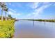 This waterfront property boasts lush foliage and plenty of calm waters for fishing, boating and other outdoor activities at 18382 Arapahoe Cir, Port Charlotte, FL 33948