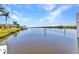 Picturesque waterfront view of the canal from the dock, showcasing lush greenery and serene water at 18382 Arapahoe Cir, Port Charlotte, FL 33948