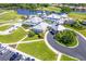 Aerial view showcasing the clubhouse amenities including pool, parking, and lush landscaping at 1903 San Silvestro Dr, Venice, FL 34285