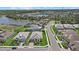 Beautiful aerial view of homes in a community with a lake and manicured lawns on a sunny day at 19800 Montenero Way, Venice, FL 34293