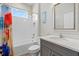 Well-lit bathroom featuring a shower-tub combination and a vanity with a quartz countertop at 19800 Montenero Way, Venice, FL 34293