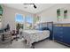 Well-lit bedroom with a desk, blue accents, and a view of the neighborhood through the window at 19800 Montenero Way, Venice, FL 34293