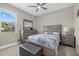 Cozy bedroom featuring natural light from the window, and neutral décor including a bed and dresser at 19800 Montenero Way, Venice, FL 34293