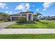 Beautiful home featuring a manicured lawn, neat landscaping, and a welcoming front facade at 19800 Montenero Way, Venice, FL 34293