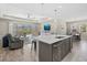 Bright, open kitchen features island, modern appliances, and seamless transition to living area and patio at 19800 Montenero Way, Venice, FL 34293