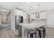 Bright kitchen featuring a central island, stainless steel appliances, and pendant lighting at 19800 Montenero Way, Venice, FL 34293