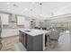 Bright, open kitchen features island, modern appliances, and seamless transition to living area and outdoor pool at 19800 Montenero Way, Venice, FL 34293