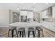 Modern kitchen with white cabinets, stainless steel appliances, and island with seating at 19800 Montenero Way, Venice, FL 34293