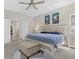 Comfortable bedroom with neutral tones, plush carpeting, and walk-in closet access at 19800 Montenero Way, Venice, FL 34293