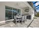Covered patio with outdoor dining table and grill, perfect for entertaining next to screened pool at 19800 Montenero Way, Venice, FL 34293