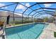 Enjoy the screened-in pool and spa with cozy seating, creating an ideal outdoor retreat at 19800 Montenero Way, Venice, FL 34293