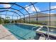 Relaxing screened-in pool and spa with lush landscaping for added privacy and a tropical feel at 19800 Montenero Way, Venice, FL 34293