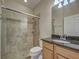 Modern bathroom with glass shower door and granite countertop vanity at 19911 Quisto St, Venice, FL 34293
