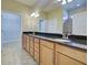 Bathroom boasts double sinks with granite countertop, a framed shower, and a walk-in closet at 19911 Quisto St, Venice, FL 34293
