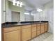 Bathroom features double sinks with granite countertop, a framed shower, and ample cabinet space at 19911 Quisto St, Venice, FL 34293