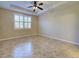 Empty bedroom with tile floors, window with shutters and ceiling fan at 19911 Quisto St, Venice, FL 34293