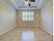 Spacious bedroom featuring tile flooring, a ceiling fan, and a bright window at 19911 Quisto St, Venice, FL 34293