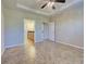 Open bedroom with tile floors, ceiling fan, ensuite bathroom, and closet at 19911 Quisto St, Venice, FL 34293