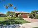 Charming single-story home with a tile roof, brick driveway, and lush tropical landscaping at 19911 Quisto St, Venice, FL 34293