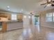 Open-concept kitchen and living area with tile floors and stainless steel appliances at 19911 Quisto St, Venice, FL 34293