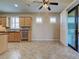 Kitchen with tile floors, wooden cabinets, and stainless steel dishwasher at 19911 Quisto St, Venice, FL 34293