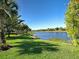 Scenic view of the lake and lush green lawn, creating a serene and picturesque outdoor space at 19911 Quisto St, Venice, FL 34293