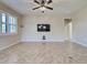 Open concept living room featuring tile flooring, and modern ceiling fan at 19911 Quisto St, Venice, FL 34293