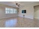 Bright living room with tile floors, large window with shutters and mounted television at 19911 Quisto St, Venice, FL 34293