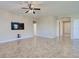Spacious living room with mounted TV and tile floors at 19911 Quisto St, Venice, FL 34293