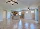 Spacious living room with open kitchen view and tile flooring at 19911 Quisto St, Venice, FL 34293