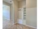 Mudroom with bench, storage shelves, and tile flooring at 19911 Quisto St, Venice, FL 34293