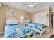 Bedroom featuring twin beds, bright decor, and overhead fan at 200 The Esplanade N # B3, Venice, FL 34285