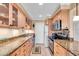 Efficient kitchen features granite countertops, wooden cabinets, and modern stainless steel appliances at 200 The Esplanade N # B3, Venice, FL 34285