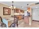 Charming kitchen and dining area with wooden cabinets, granite countertops, and natural lighting at 200 The Esplanade N # B3, Venice, FL 34285
