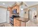 Cozy kitchen featuring wood cabinetry, granite countertop space and modern stainless-steel appliances at 200 The Esplanade N # B3, Venice, FL 34285