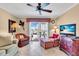 Relaxing living room features sliding glass doors to a private balcony with comfortable seating and a TV at 200 The Esplanade N # B3, Venice, FL 34285