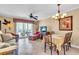 Cozy living room with tile flooring and open access to the dining area, seamlessly connects indoor and outdoor living at 200 The Esplanade N # B3, Venice, FL 34285