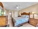 Main bedroom features lamps, comfortable bed, bureau, and ceiling fan at 200 The Esplanade N # B3, Venice, FL 34285