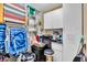 Organized storage area with pegboard walls, cabinets, cleaning and beach supplies neatly arranged at 200 The Esplanade N # B3, Venice, FL 34285