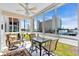 A sunroom with chairs, table, and lots of windows for natural light at 200 The Esplanade N # B3, Venice, FL 34285